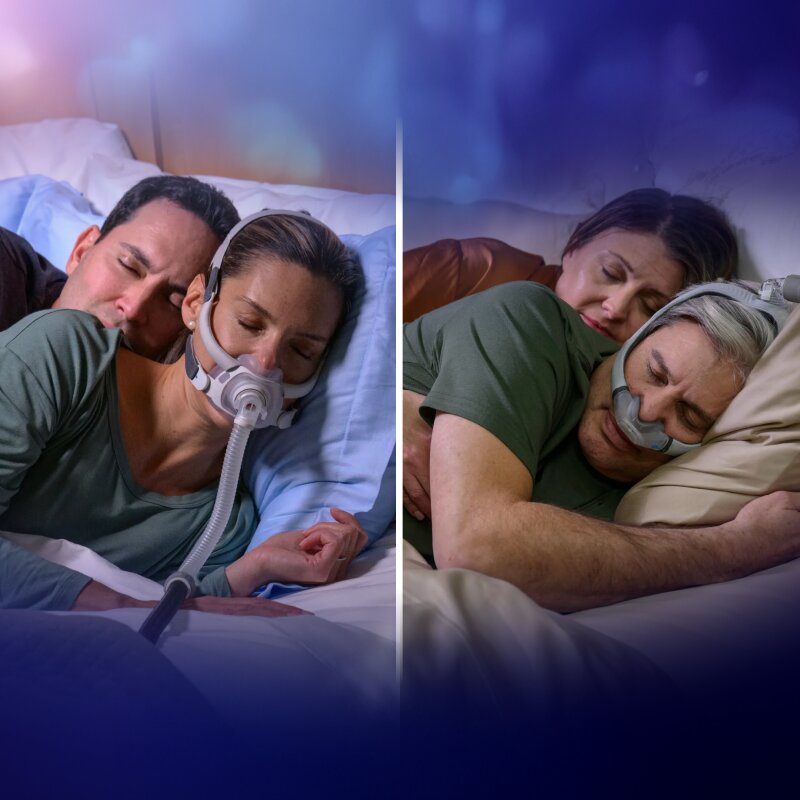 Man wearing Resmed's AirFit N20 CPAP Mask while his partner is reading in bed