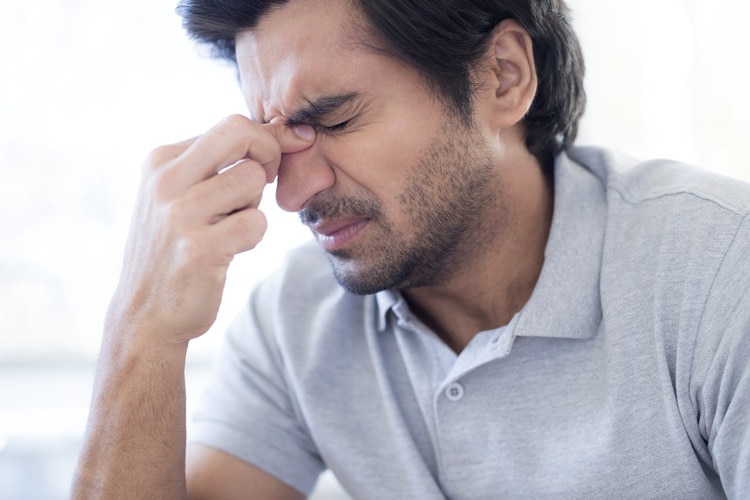  Man rubbing bridge of nose