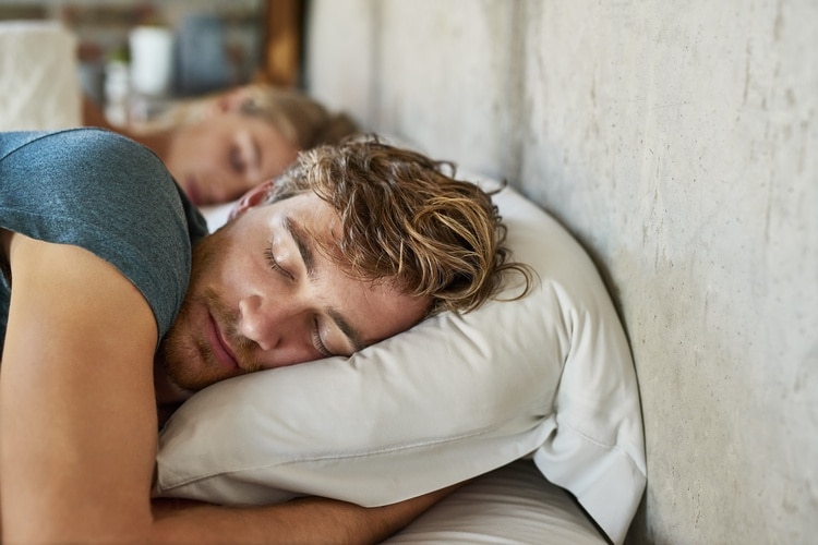 Man sleeping on his side, with pillow