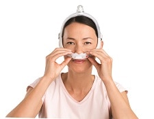 Lady adjusting her P30i CPAP mask