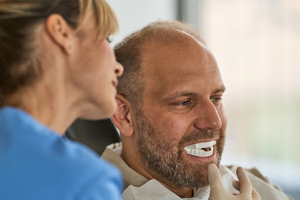  man being fitted with oral appliance