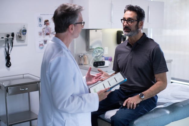  Male patient in exam room with doctor