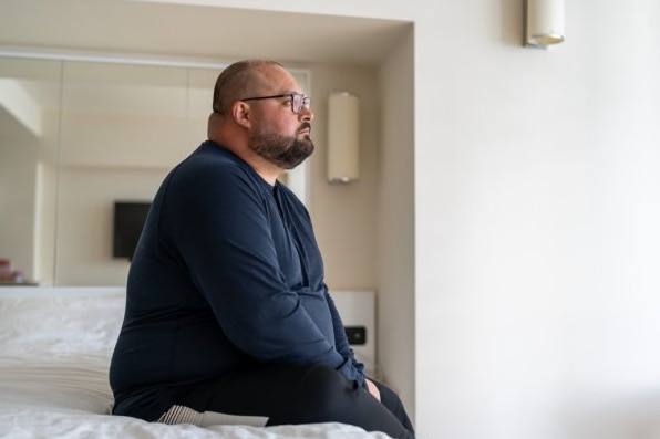  Restless man sitting on bed