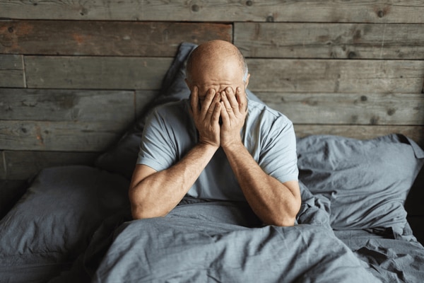  man struggling to sleep