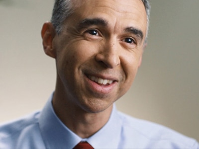 A doctor from a sleep centre smiling as he talks about sleep apnoea tests.