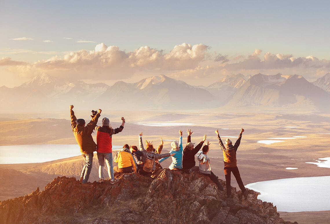 Friends happy on top of a mountain